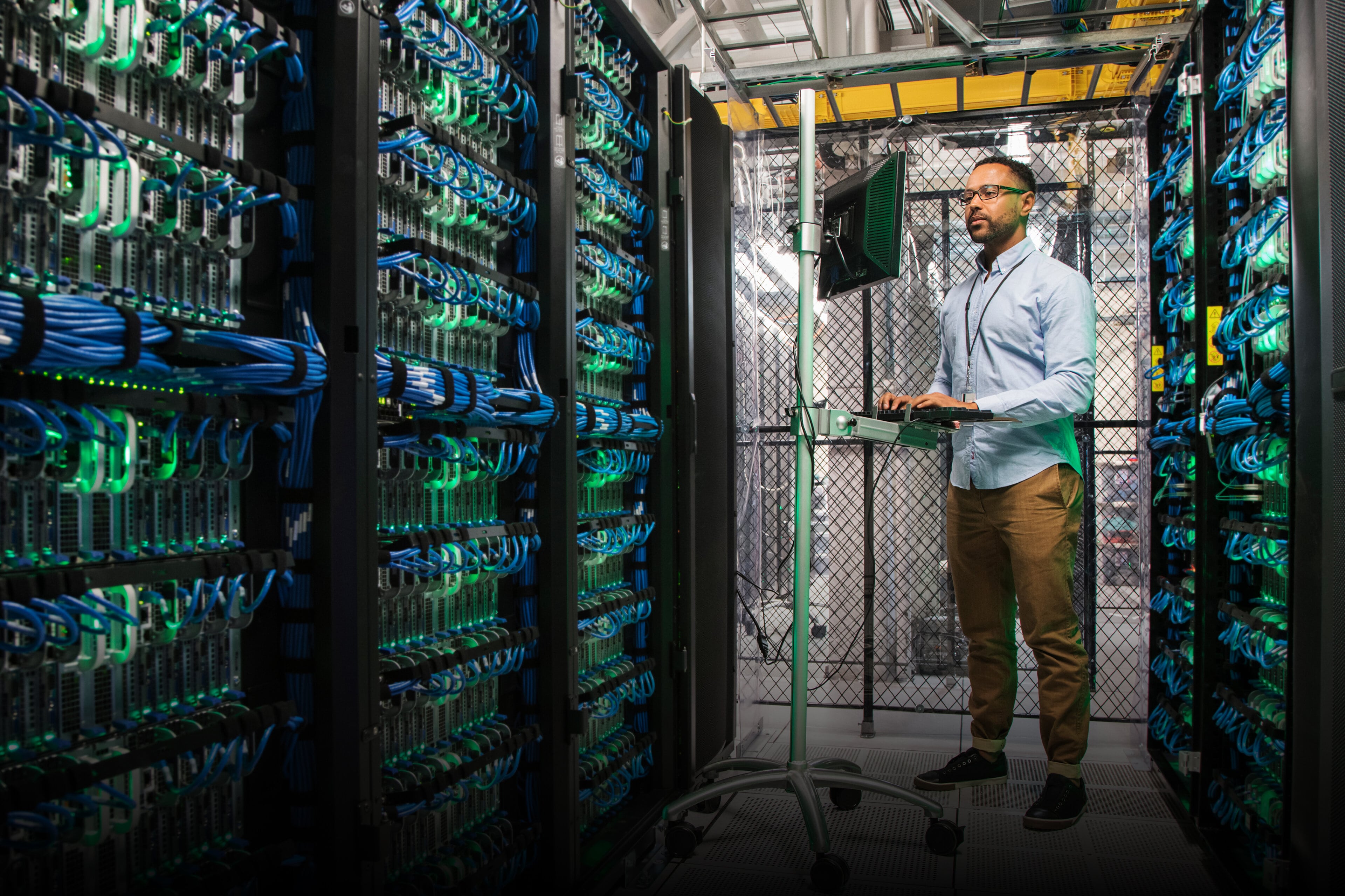 Image depicting a man working at a database center